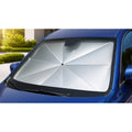 Luvenzo AutoShade sun shade umbrella open inside the windshield of a blue car, reflective silver canopy blocking sunlight